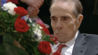 Bob Dole Stands To Salute Casket Of Late Former President George H.W. Bush